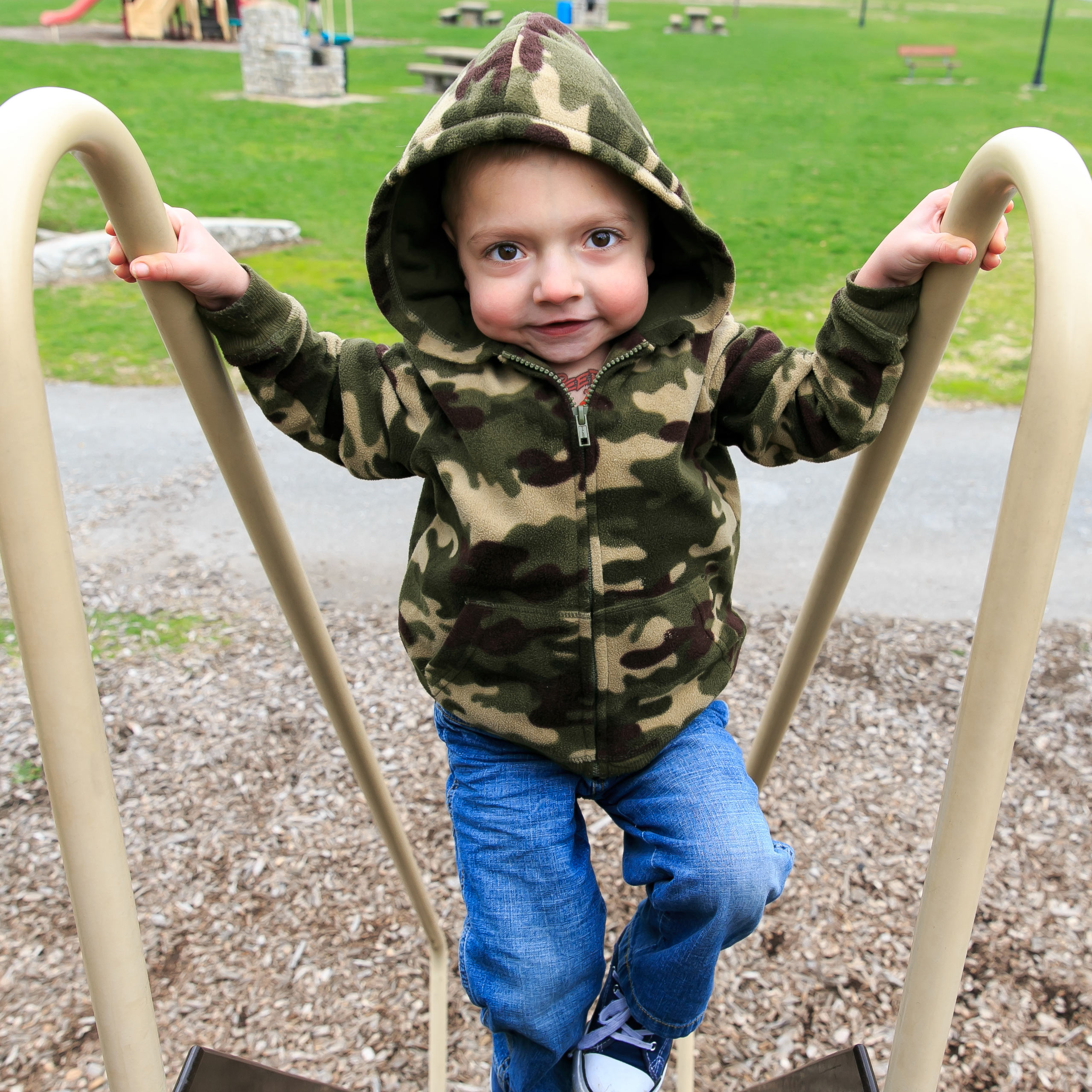 Tanner, diagnosed with HPP at 4 days old, playing on a playground